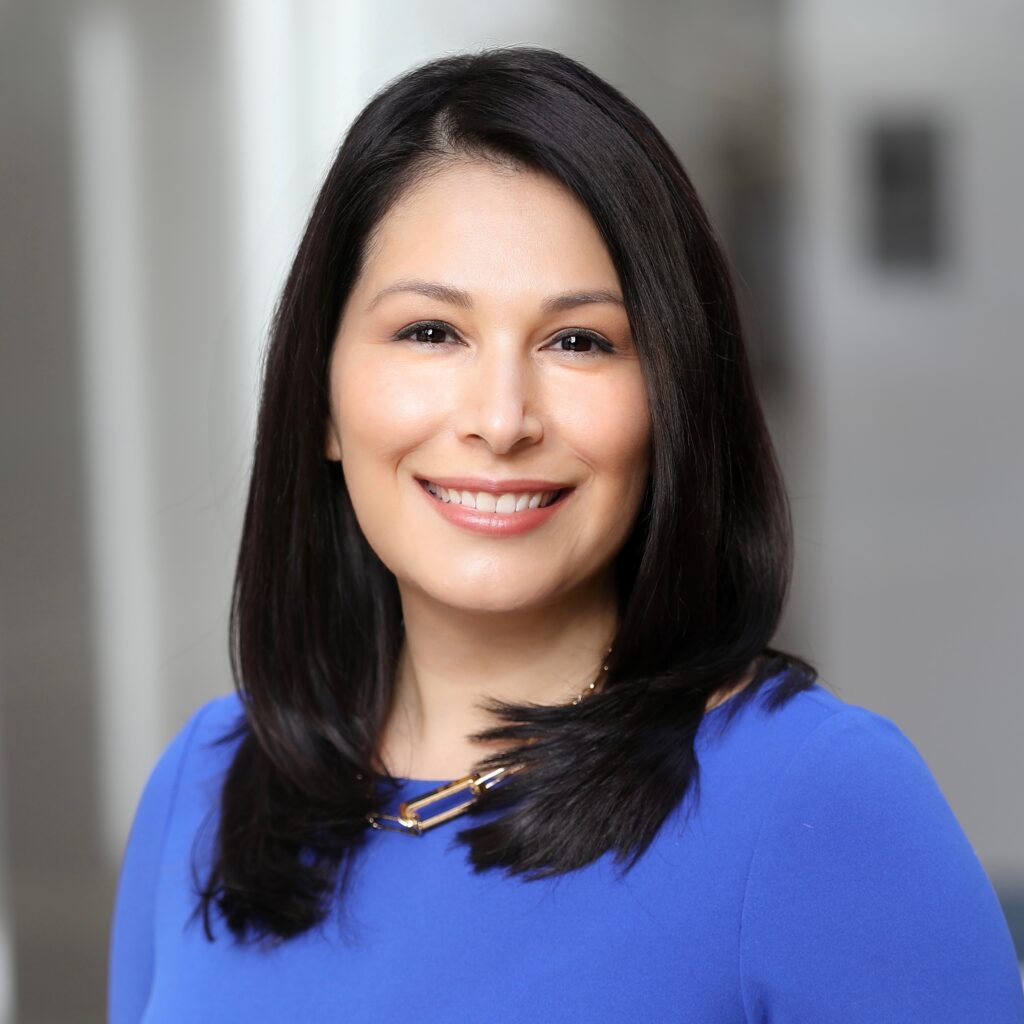 A headshot of Melissa Luna with a blurred background.