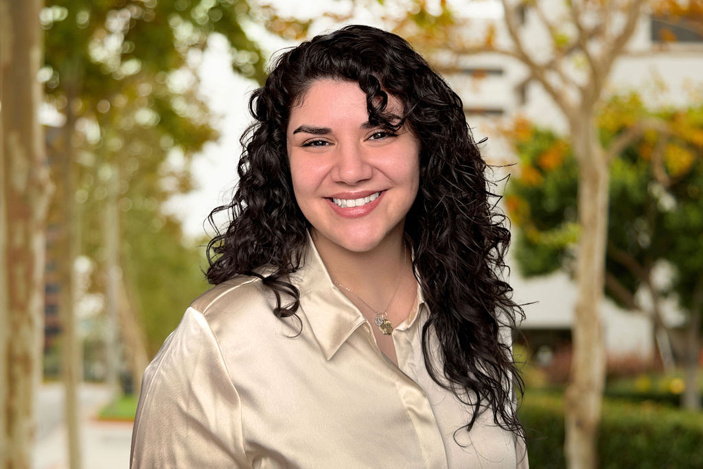 Portrait of Emily Montes with a nature background.