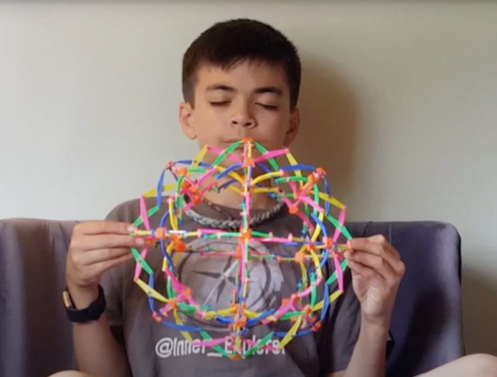 A young student using a colorful mindfulness toy from Inner Explorer.