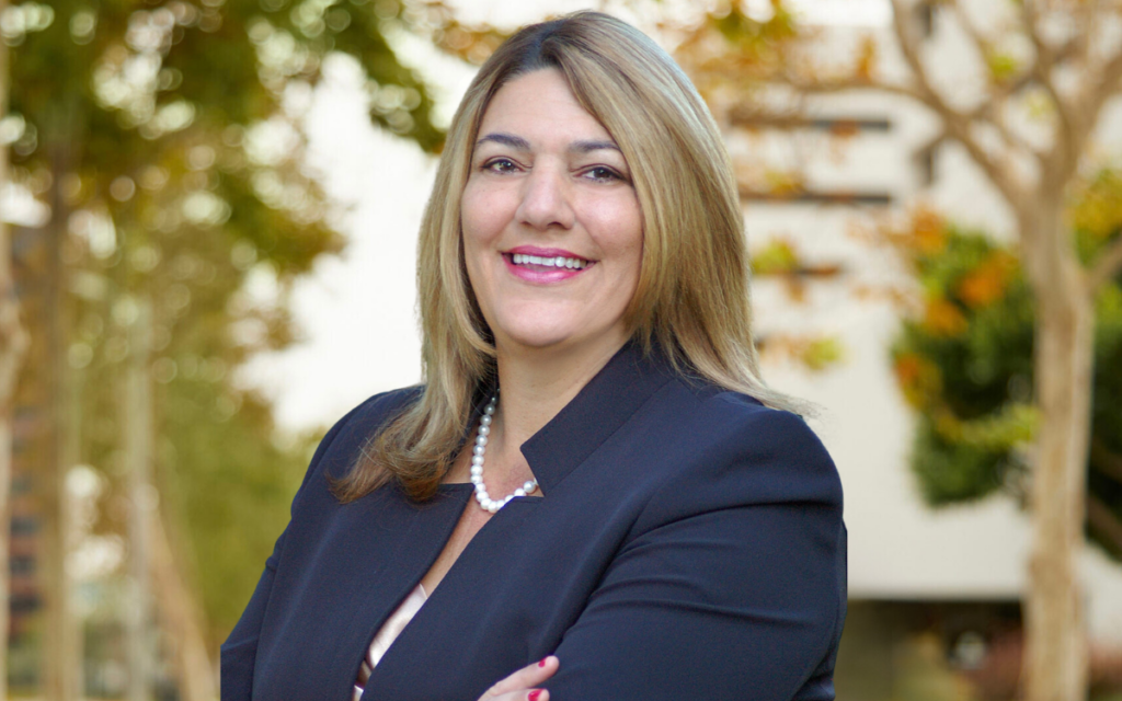 Portrain of Madeline Pumariega, President of Miami Dade College, on a forrest background