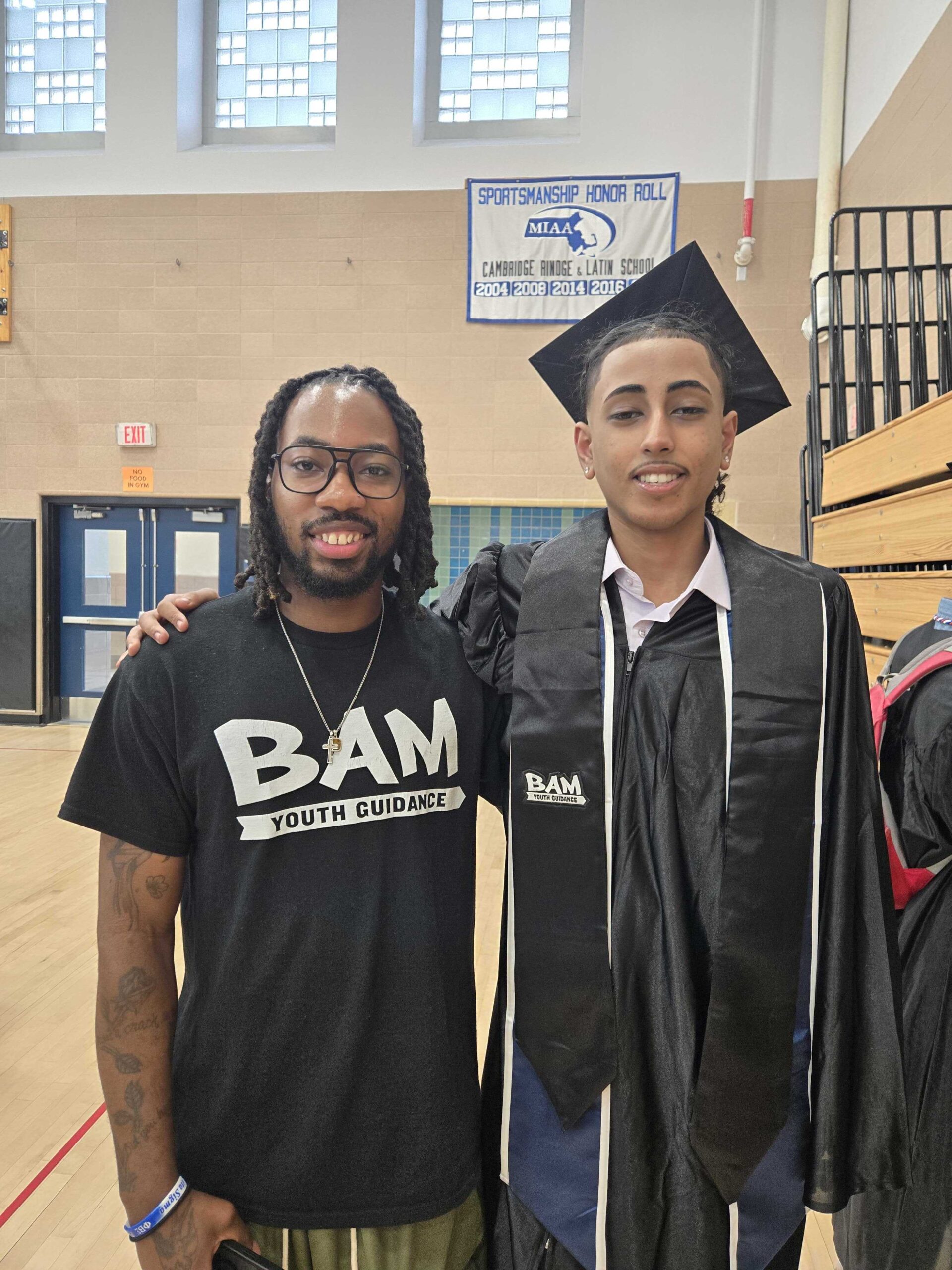 A picture of a BAM participant at graduation with their BAM mentor.